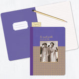 The Shannon Martin Design So Much World Journal, with jewel tones and gold foil accents, features a vintage photo and the phrase "So much world, so little time," shown atop an open lined notebook with a pencil on a white surface.