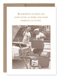 The "Living Retirement Card" from Shannon Martin Design features a vintage image of a man and woman beside an open car trunk, packing suitcases and a vacuum cleaner. The text above reads, "Retirement is when you stop living at work and start working at living," printed on FSC-certified paper for enhanced sustainability.