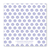 The Not Going To Work Napkin by Shannon Martin Design is a white square beverage napkin with a repeating pattern of small, purple, stylized flowers. Text at the bottom reads © Shannon Martin Design and shannonmartindesign.com. Biodegradable for eco-friendly charm.