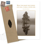 The Heart Never Lose Sympathy Card by Shannon Martin Design is made from recycled paper, featuring a sepia tree reflection photo and heartfelt quote, paired with an envelope adorned with vintage stamps for a classic touch.