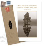 The Heart Never Lose Sympathy Card by Shannon Martin Design is made from recycled paper, featuring a sepia tree reflection photo and heartfelt quote, paired with an envelope adorned with vintage stamps for a classic touch.