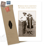 The Shannon Martin Design “Marriage Means Commitment Anniversary Card” features a vintage couple photo and witty text, printed on recycled paper. The card is paired with a brown envelope decorated with old-style postage stamps.