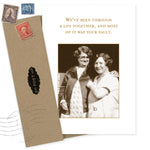 The "Your Fault Friendship / Just Because Card" by Shannon Martin Design features a sepia photo of two smiling women arm-in-arm and reads: "We’ve been through a lot together, and most of it was your fault." Made in the USA.