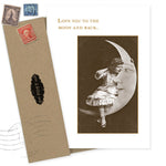 The Little Girl On Moon Love Card by Shannon Martin Design features a vintage photo of a girl on a crescent moon with "LOVE YOU TO THE MOON AND BACK." Made in the USA with recycled paper, it includes a brown envelope and old postage stamps.