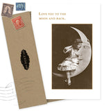 The Little Girl On Moon Love Card by Shannon Martin Design features a vintage photo of a girl on a crescent moon with "LOVE YOU TO THE MOON AND BACK." Made in the USA with recycled paper, it includes a brown envelope and old postage stamps.