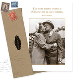 The Best Thing Anniversary Card by Shannon Martin Design features a vintage couple kissing and the quote, "The best thing to hold onto in life is each other. – Audrey Hepburn." Comes with a brown recycled envelope with postage stamp accents.