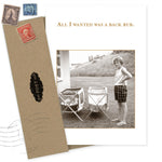 The “All I Wanted What A Hoot Card” by Shannon Martin Design features a sepia photo of a woman beside two folding chairs, with text above: “All I wanted was a back rub.” Includes a vintage envelope and is made in the USA.