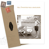 The “All I Wanted What A Hoot Card” by Shannon Martin Design features a sepia photo of a woman beside two folding chairs, with text above: “All I wanted was a back rub.” Includes a vintage envelope and is made in the USA.