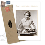 The What A Friend Birthday Card by Shannon Martin Design features a vintage-style image of a smiling woman holding a cheese platter, with the caption “What a friend we have in cheeses,” and comes with two envelopes bearing old stamps. Made in the USA.