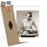 The What A Friend Birthday Card by Shannon Martin Design features a vintage-style image of a smiling woman holding a cheese platter, with the caption “What a friend we have in cheeses,” and comes with two envelopes bearing old stamps. Made in the USA.