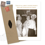 A sepia photo of three smiling adults in fun hats, including a balloon hat. Above, the text reads: Life is all about finding people who are your kind of crazy. "Your Kind Of Crazy Birthday Card" by Shannon Martin Design, with a recycled envelope, is shown.