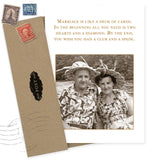 A sepia photo of a smiling couple in floral shirts and hats features on the Shannon Martin Design Deck Of Cards Anniversary Card, which reads: "Marriage is like a deck of cards..." The envelope with vintage stamps says, "Made in USA.