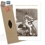 The Carpe Diem Birthday Card by Shannon Martin Design features a sepia photo of a smiling woman on a vintage motorcycle, a brown envelope with old postage stamps, and gold "Carpe the hell out of this diem." text, printed on recycled paper.