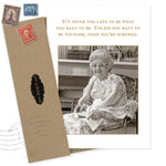 The Shannon Martin Design Never Too Late Birthday Card features a vintage photo of an elderly woman in glasses and a crocheted shawl holding a plate, with the message: It’s never too late to be what you want—unless you want to be younger!.