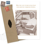 The Shannon Martin Design “Driving Terrifies Birthday Card” features a vintage sepia photo of an elderly man in glasses and cap with a cane sitting in a car, plus the message: May you live to be so old that your driving terrifies people. Envelope and stamps included.