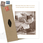 The Reading Enough Birthday Card by Shannon Martin Design features a vintage image of a smiling woman in a chair reading, with the caption: "Anyone who has time to clean, is not reading nearly enough." Envelope and stamps included. Made in USA.