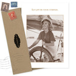 The Joy Be Compass Birthday Card by Shannon Martin Design features a sepia-toned photo of a smiling woman in a sailor hat, the phrase "Let joy be your compass," and includes a brown envelope with vintage stamps. Made from recycled paper.