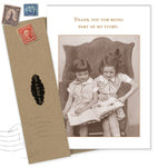 The Part Of My Story Friendship / Just Because Card by Shannon Martin Design features two girls reading on a chair with "Thank you for being part of my story" text. Crafted in the USA, it includes a brown envelope and vintage-style stamps.