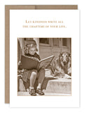 A sepia-toned image of a young girl absorbed in her book on recycled paper, with a dog at her side, graces the "Kindness Thank You Card" by Shannon Martin Design. Above them, the words "Let kindness write all the chapters of your life" evoke the nostalgic charm of cherished vintage photos.