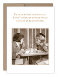 The Glad We Met Birthday Card by Shannon Martin Design showcases a nostalgic sepia-toned photo of two women laughing at a table. The text above the image humorously states, "I'm glad we met later in life. I don't think my mother would have let me play with you." Crafted on recycled paper, it exudes vintage-style charm.