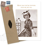The "Rude, You're Younger Than Me Birthday Card" by Shannon Martin Design features a smiling woman in a retro dress and hat on recycled paper, with the cheeky quote, "Rude that you're younger than me, but ok." Includes a brown envelope.