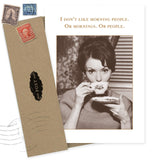 The Morning People Birthday Card by Shannon Martin Design features a sepia vintage photo of a woman drinking tea and the message: "I don’t like morning people. Or mornings. Or people." Includes brown recycled paper envelope with vintage stamps.