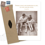 The One Happiness Anniversary Card by Shannon Martin Design features a black-and-white photo of a smiling couple in a rowboat and the quote, “There is only one happiness in life, to love and be loved. — George Sand.” Printed on recycled paper.