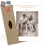 The One Happiness Anniversary Card by Shannon Martin Design features a black-and-white photo of a smiling couple in a rowboat and the quote, “There is only one happiness in life, to love and be loved. — George Sand.” Printed on recycled paper.