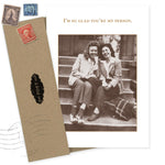 The "You're My Person Friendship / Just Because Card" by Shannon Martin Design features two smiling women on outdoor steps and the caption “I’m so glad you’re my person.” Made of recycled paper, it comes with a brown envelope adorned with vintage stamps.