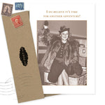 The Another Adventure Friendship / Just Because Card by Shannon Martin Design features a smiling woman in a fur coat on luggage, arm raised, with the message, "I do believe it’s time for another adventure!" Made in the USA. Envelope and stamps included.