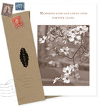 The Memories Sympathy Card by Shannon Martin Design is made in the USA, featuring sepia-toned flowers and the message "Memories keep our loved ones forever close," paired with a brown envelope, vintage stamps, and a black POST label.
