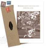 The Memories Sympathy Card by Shannon Martin Design is made in the USA, featuring sepia-toned flowers and the message "Memories keep our loved ones forever close," paired with a brown envelope, vintage stamps, and a black POST label.