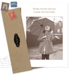 The Feeling Under The Weather Get Well Card by Shannon Martin Design features a sepia photo of a girl with an umbrella, text reading "Sorry you’re feeling under the weather," and comes with a vintage-style stamped envelope. Made in the USA.
