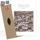 The Ever Thanks Thank You Card by Shannon Martin Design features a sepia daisy photo and a Shakespeare quote. Includes an envelope with vintage stamps and a black POST label, partially open. Made in the USA.