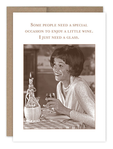 A woman smiles with a glass of wine at a table with a decanter, echoing vintage photos from Shannon Martin Designs collection. The text reads, Some people need a special occasion to enjoy wine. I just need a glass. Featuring the Special Occasion Birthday Card.