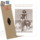 The Looks Aren't Everything Birthday Card by Shannon Martin Design features a sepia swimsuit photo with the witty text, "I know looks aren’t everything, but I have them, just in case." Includes envelope and stamps. Made in USA.