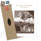 The Fixin' To Get In Trouble What A Hoot Card by Shannon Martin Design features two smiling women chatting over a fence with the phrase “I’m fixin’ to get in trouble. You comin’?” Includes a brown envelope with vintage stamps. Made in the USA.