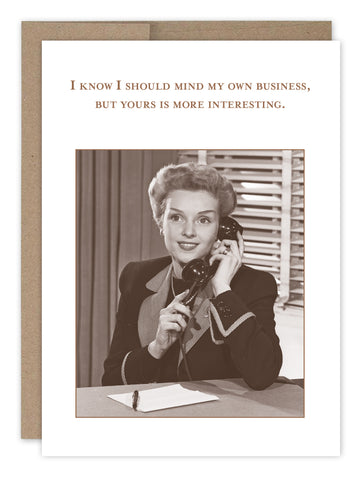 The Mind My Own Business Birthday Card by Shannon Martin Design features a vintage-style image of a smiling woman with a telephone, notepad, and pen, plus the text: I know I should mind my own business, but yours is more interesting. Made in the USA.