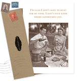 The Sandwiches Birthday Card by Shannon Martin Design features a smiling man and woman enjoying a picnic with sandwiches and drinks, printed on recycled paper. An envelope with vintage stamps completes the nostalgic, eco-friendly charm.