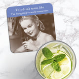 The Not Going To Work Coaster by Shannon Martin Design features a vintage woman with a drink and the witty line “This drink tastes like I’m not going to work tomorrow” on a heat and water-resistant, cork-backed surface.