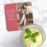 The Bad Decisions Coaster by Shannon Martin Design—a cork-backed, heat and water resistant coaster—displays a retro photo of a smiling woman with "You bring the alcohol, I'll bring the bad decisions" beside a refreshing lime and mint drink.