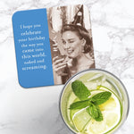 The Into This World Coaster by Shannon Martin Design features a retro photo of a smiling woman in a hat with a drink. Text: "I hope you celebrate your birthday the way you came into this world, naked and screaming.