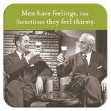 Two men in suits toast with beer glasses on cork-backed, heat & water resistant "Men Have Feelings Coaster" by Shannon Martin Design. Smiling, they enjoy a retro moment under the text: Men have feelings, too. Sometimes they feel thirsty.