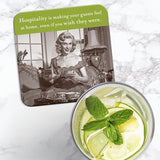 The Hospitality Coaster by Shannon Martin Design, featuring a vintage woman with teapot and a witty hospitality quote, rests on marble beside citrus mint water—a charming retro-style hostess gift.