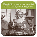 A vintage-style image of a woman with a teacup, surrounded by a lavish tea set and cork-based Hospitality Coasters by Shannon Martin Design in an ornate room. Text above reads, Hospitality is making your guests feel at home, even if you wish they werent.