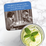 The Glad We Met Coaster by Shannon Martin Design features two women laughing at a café with a witty quote.
