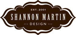 Dark brown decorative logo with the text Est. 2001 Shannon Martin Design in white, featuring a vintage border.