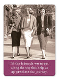Three women in vintage attire walk arm-in-arm, smiling. Caption: It’s the friends we meet along the way that help us appreciate the journey—featured on the Friends We Meet Magnet by Shannon Martin Design. Perfect for vintage photo lovers!.