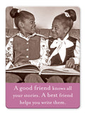 Two smiling girls sit together, holding a book and sharing a joyful moment. Text: "A good friend knows all your stories. A best friend helps you write them." All Your Stories Magnet by Shannon Martin Design—perfect for gifts or your fridge.