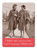 Two women in vintage outfits walk arm-in-arm, smiling. Below: “I didn’t say it was your fault. I said I was going to blame you.” The Blame You Magnet by Shannon Martin Design—perfect for lovers of quirky gifts and vintage photography!.